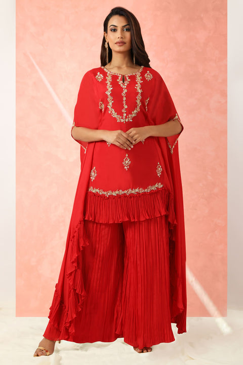 Red crepe high low tunic with gathers at the hem with gathered pallazo.
