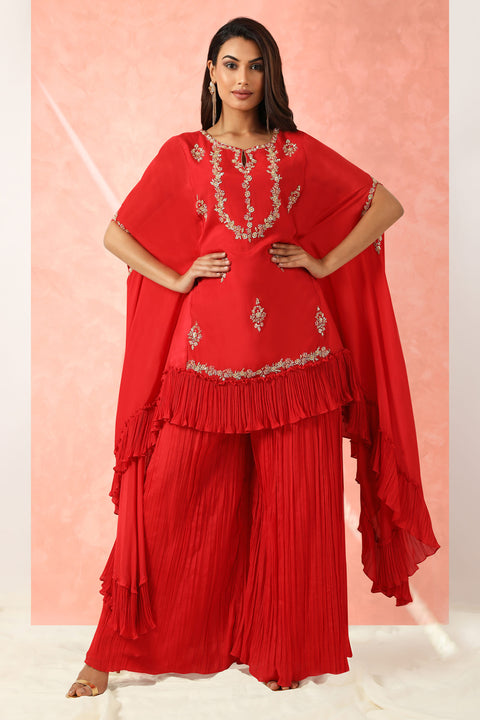 Red crepe high low tunic with gathers at the hem with gathered pallazo.