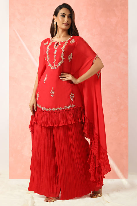 Red crepe high low tunic with gathers at the hem with gathered pallazo.