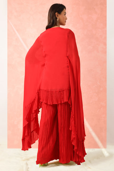 Red crepe high low tunic with gathers at the hem with gathered pallazo.