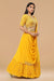 Mustard yellow skirt with gathers below and attached drape from the waist with crop top.