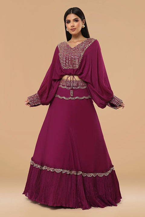 Poncho style crop top with tie up and flare rushed skirt.