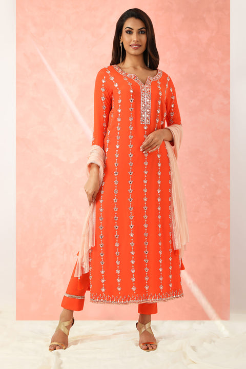 Orange embroidered tunic with matching pants and contrast dupatta.