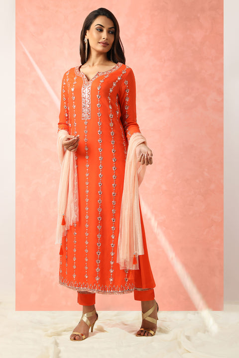 Orange embroidered tunic with matching pants and contrast dupatta.
