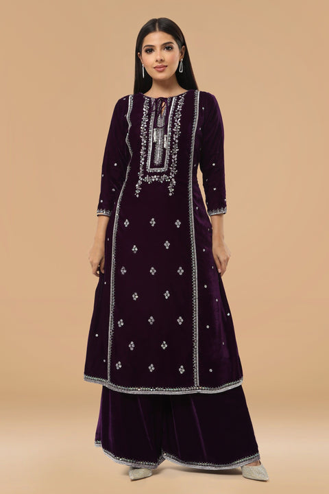Purple A line velvet kurta with matching pallazo and contrast dupatta.