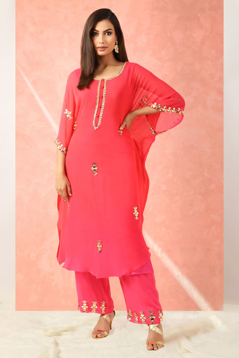 Fuchsia pink kaftan style tunic with straight pallazo pants.