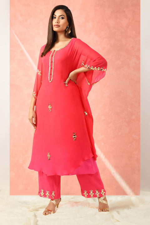 Fuchsia pink kaftan style tunic with straight pallazo pants.