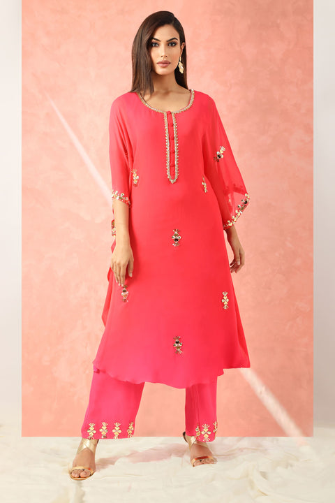 Fuchsia pink kaftan style tunic with straight pallazo pants.