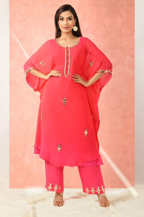 Fuchsia pink kaftan style tunic with straight pallazo pants.