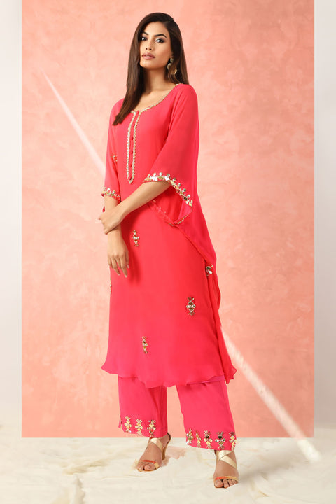 Fuchsia pink kaftan style tunic with straight pallazo pants.