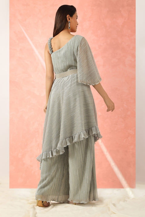 Grey shimmer one shoulder tunic with ruffles paired with pallazo and belt.