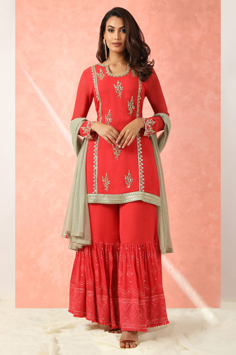 Red georgette kurta with gharara and gold dupatta.