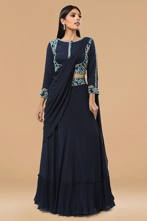 Navy blue crop top in crepe paired with skirt and a attached drape.