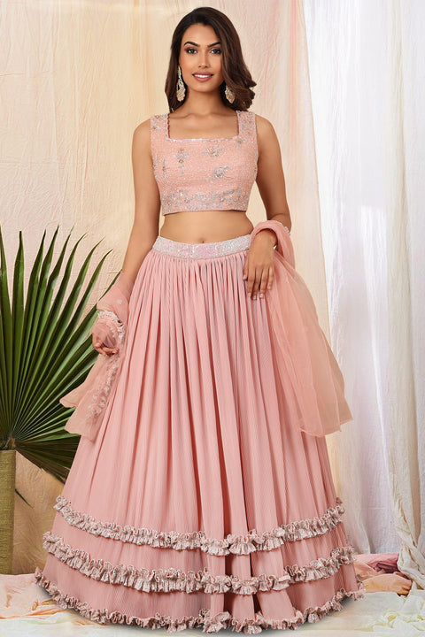 Peach textured fabric skirt with crop top and dupatta.