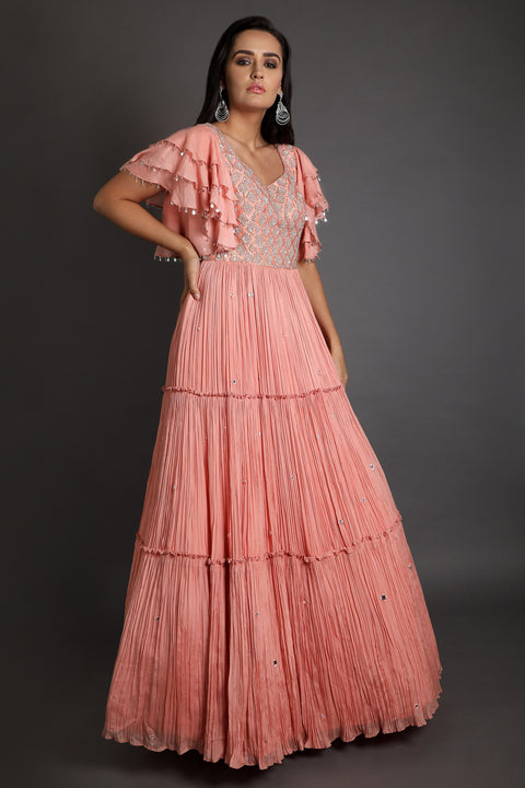 Peach ruffles embroidered rushed layered gown.