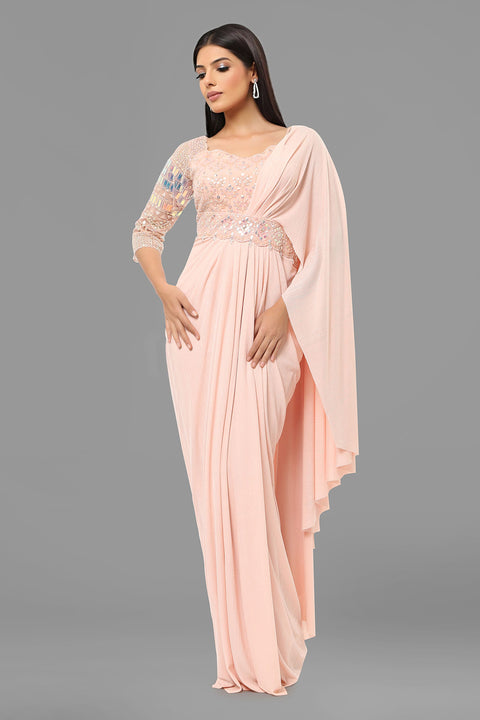 Baby pink draped saree gown with embellishments.