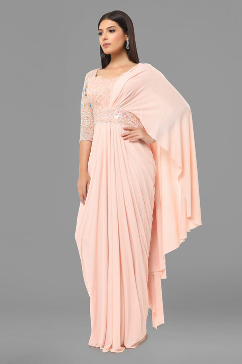 Baby pink draped saree gown with embellishments.