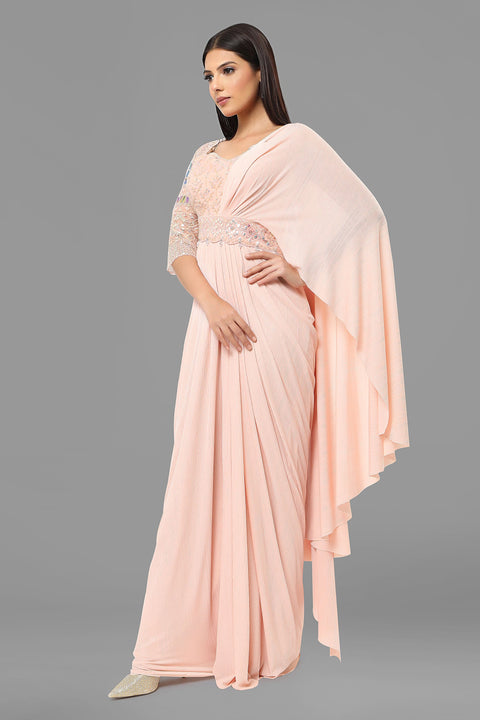 Baby pink draped saree gown with embellishments.