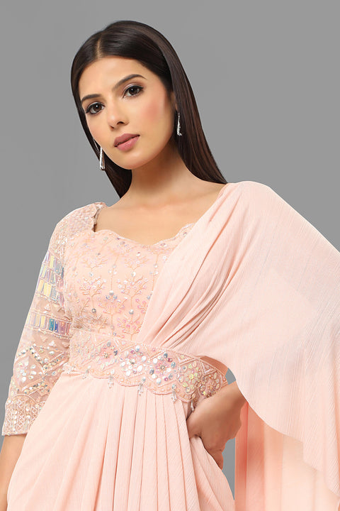 Baby pink draped saree gown with embellishments.