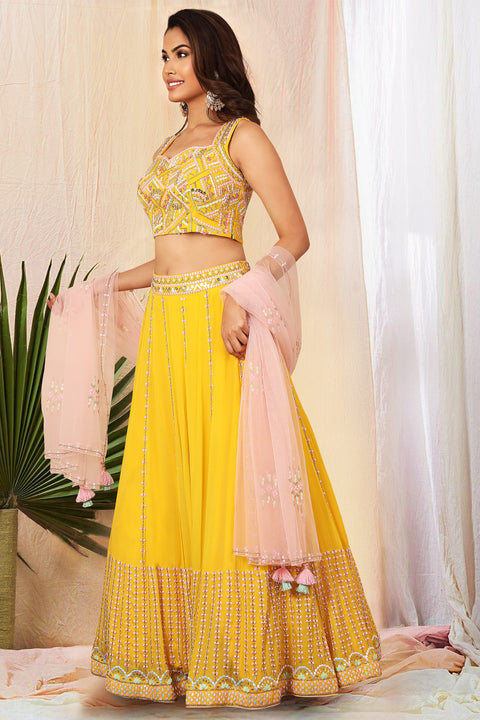 Mustard yellow flared skirt with matching crop top and contrast babypink dupatta.