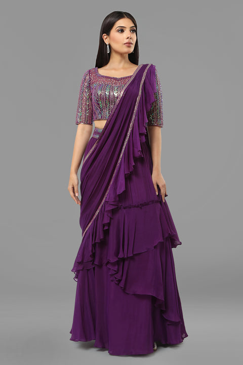 Purple embroidered crop top with layered flared skirt and draped ruffled dupatta in crepe fabric.