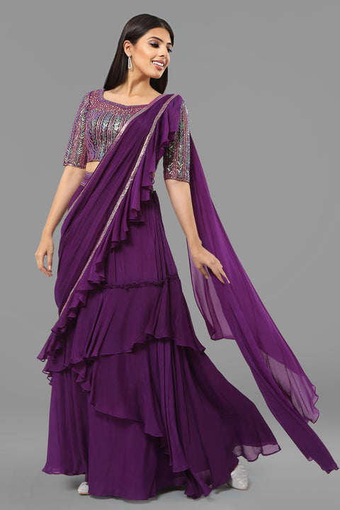 Purple embroidered crop top with layered flared skirt and draped ruffled dupatta in crepe fabric.