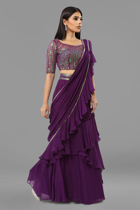 Purple embroidered crop top with layered flared skirt and draped ruffled dupatta in crepe fabric.