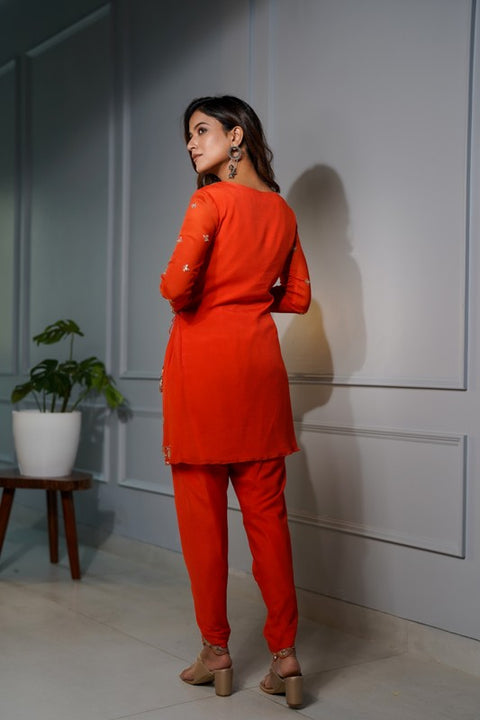 Orange crepe short tie up tunic with dhoti set.