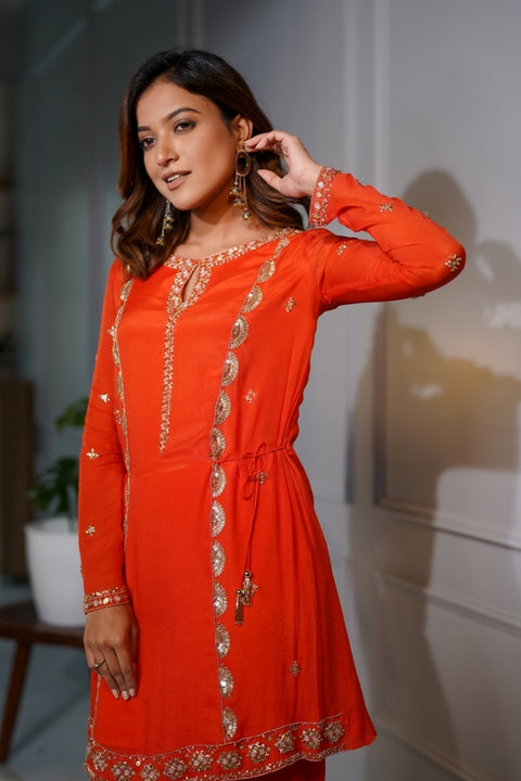 Orange crepe short tie up tunic with dhoti set.