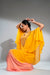 Mustard and  pink cape style flowy poncho with draped skirt.