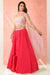 Fuchsia pink flared skirt with crop top and dupatta.
