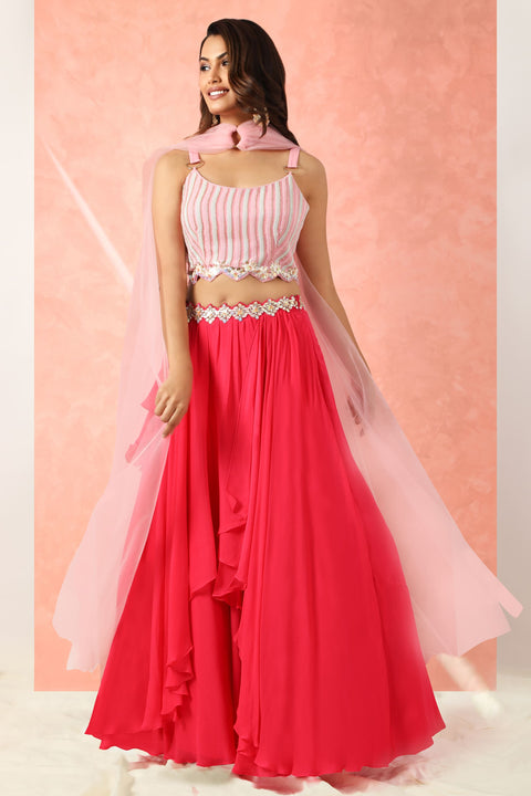 Fuchsia pink flared skirt with crop top and dupatta.