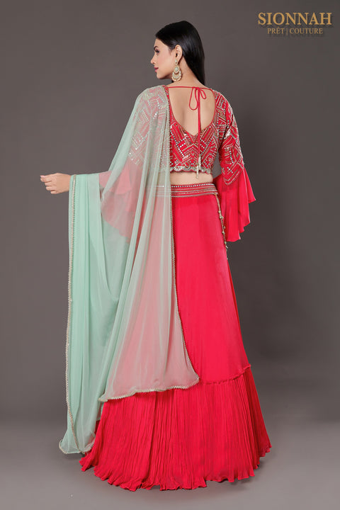 Coral pink layered skirt with accessory and crop top and skirt and dupatta.