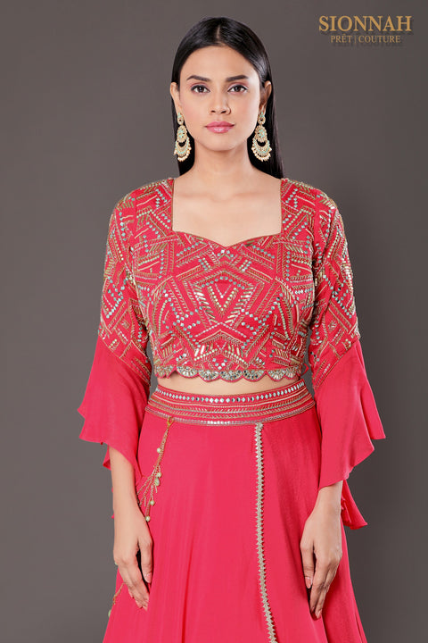 Coral pink layered skirt with accessory and crop top and skirt and dupatta.